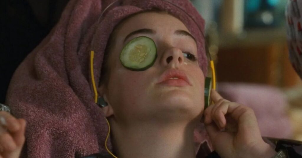 Person relaxing with cucumber on eyes, facial spa concept.