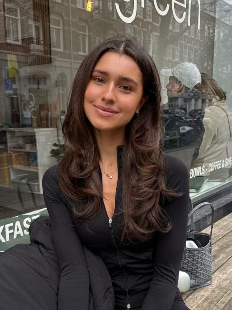Woman smiling in front of cafe window